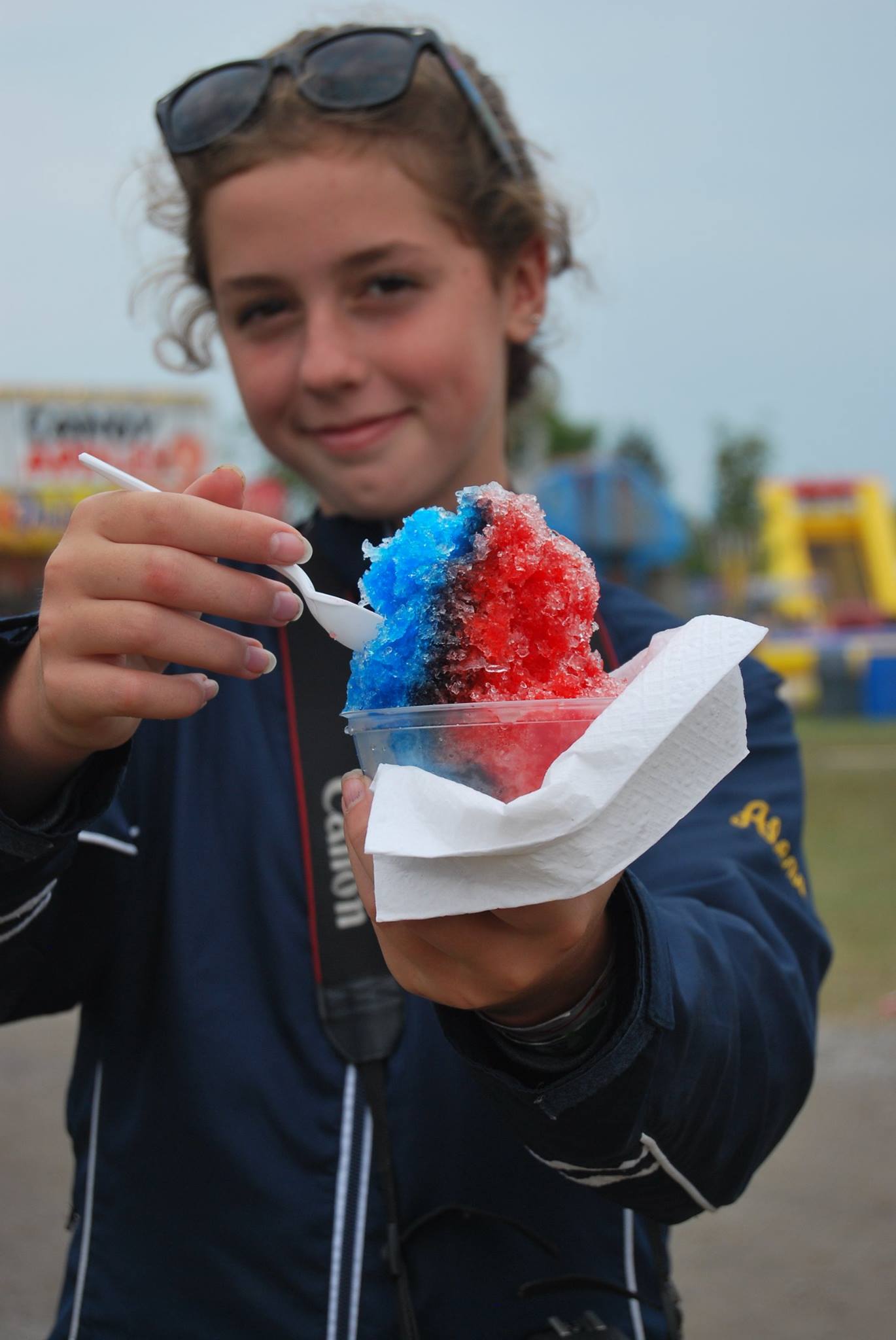 Young girl showing off her red and blue snowcone at Stormont County Fair.