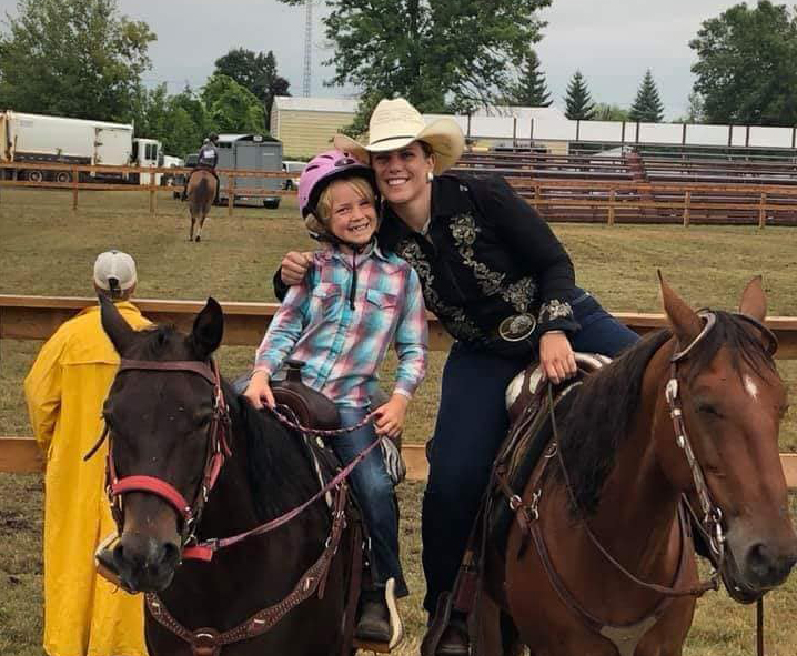 happy girl and woman on horses