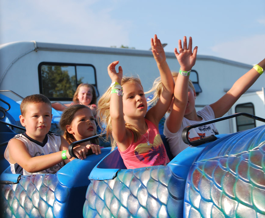 Group of kids enjoying the roller coaster at the Stormont County Fair Midway